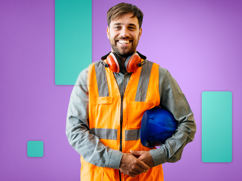 industrial man in orange vest holding blue hard hat