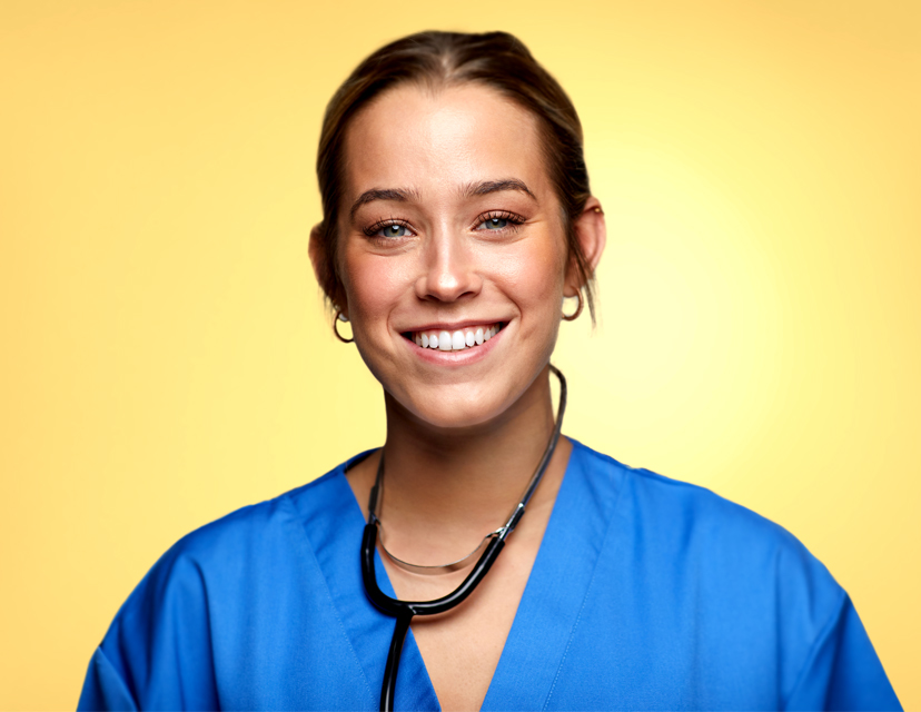 young female nurse wearing blue scrubs with stethoscope