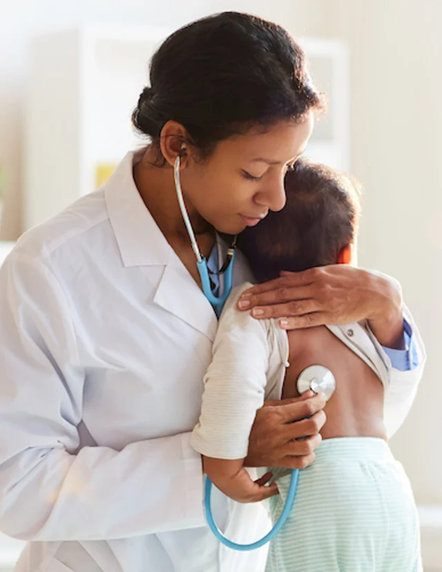 doctor with a stethoscope holding baby