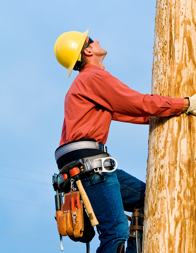 man climbing utility pole
