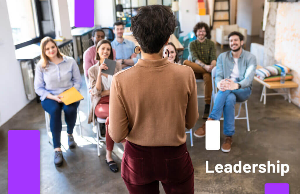 Team members engaged in a discussion led by a presenter, illustrating the process of building a leadership team