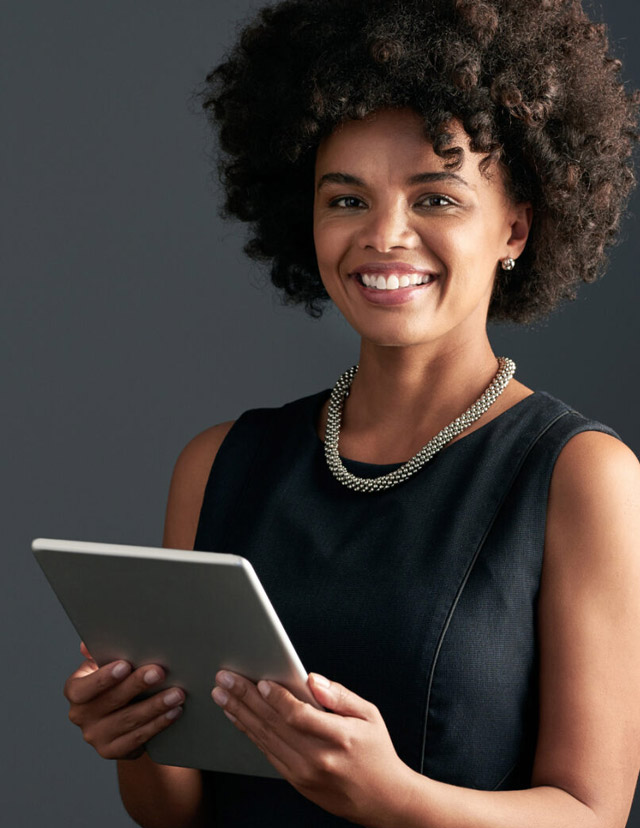 a woman standing and holding an ipad