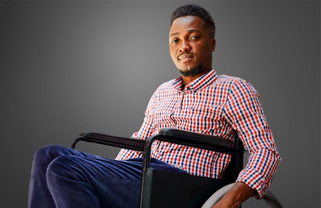 man in checkered shirt posing for camera