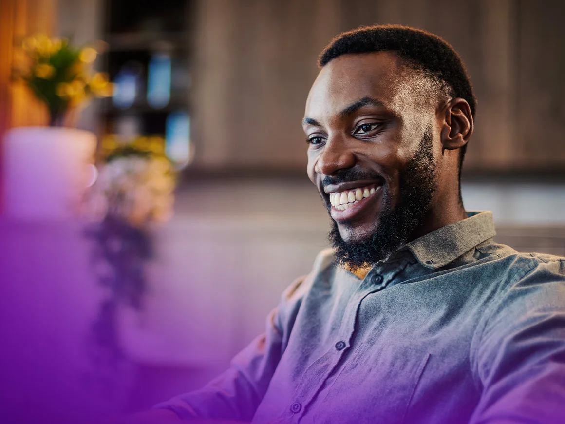 man wearing gray shirt smiling