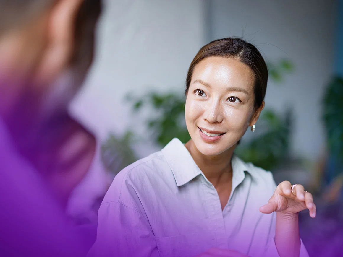 woman gesturing while having a conversation