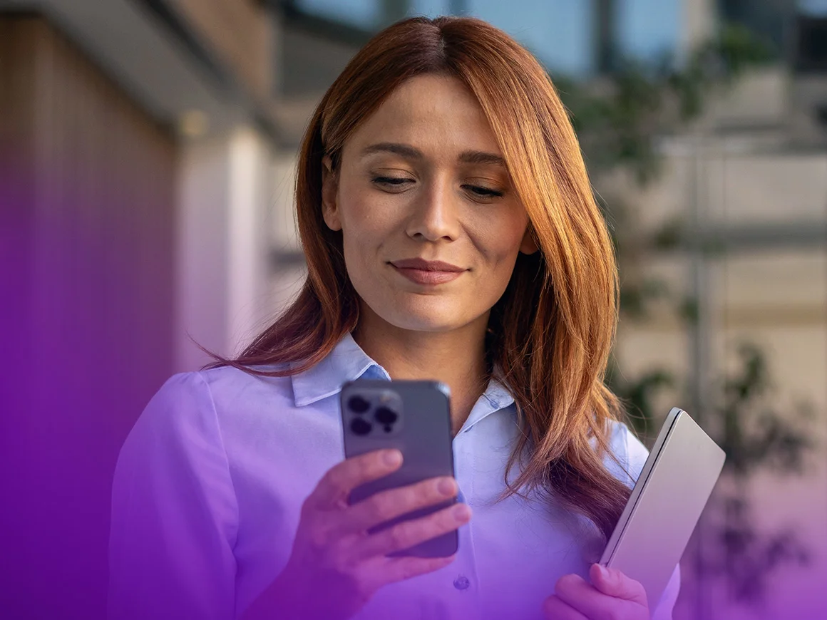 woman looking at phone and smiling