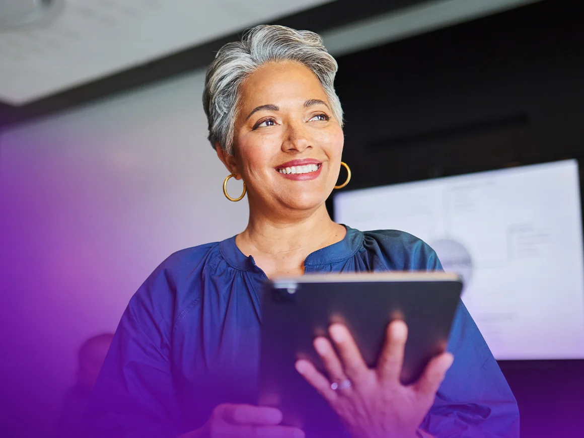 woman wearing a blue shirt using a tablet
