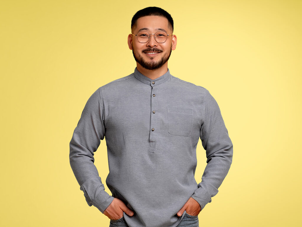 man wearing a grey quarter button down