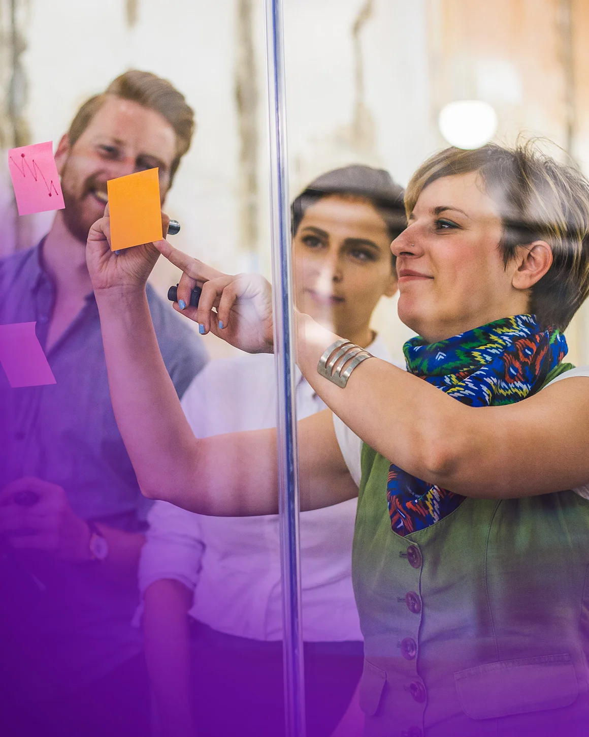 group of people looking at sticky notes
