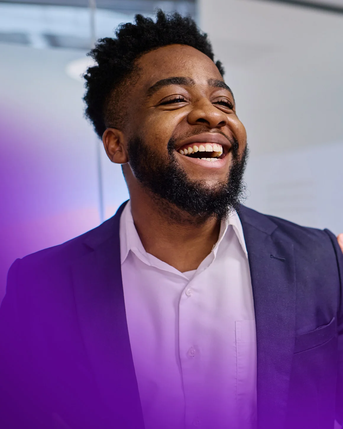 man wearing a suit smiling and conversing