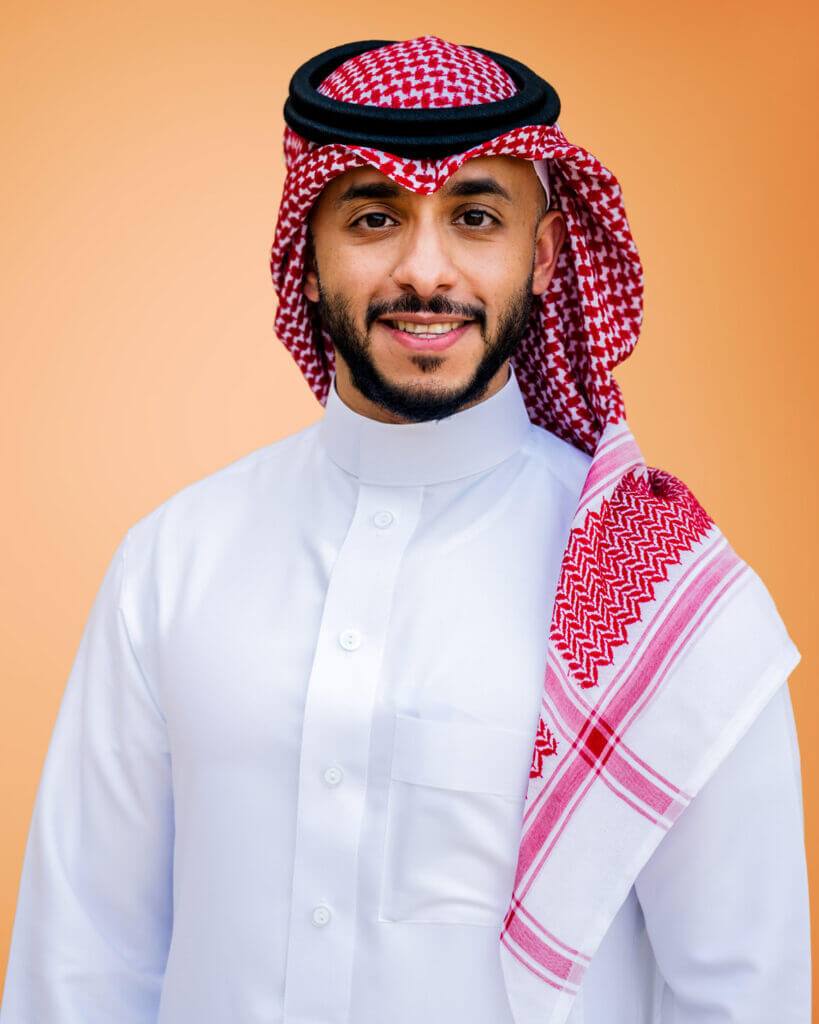 man with arms crossed smiling