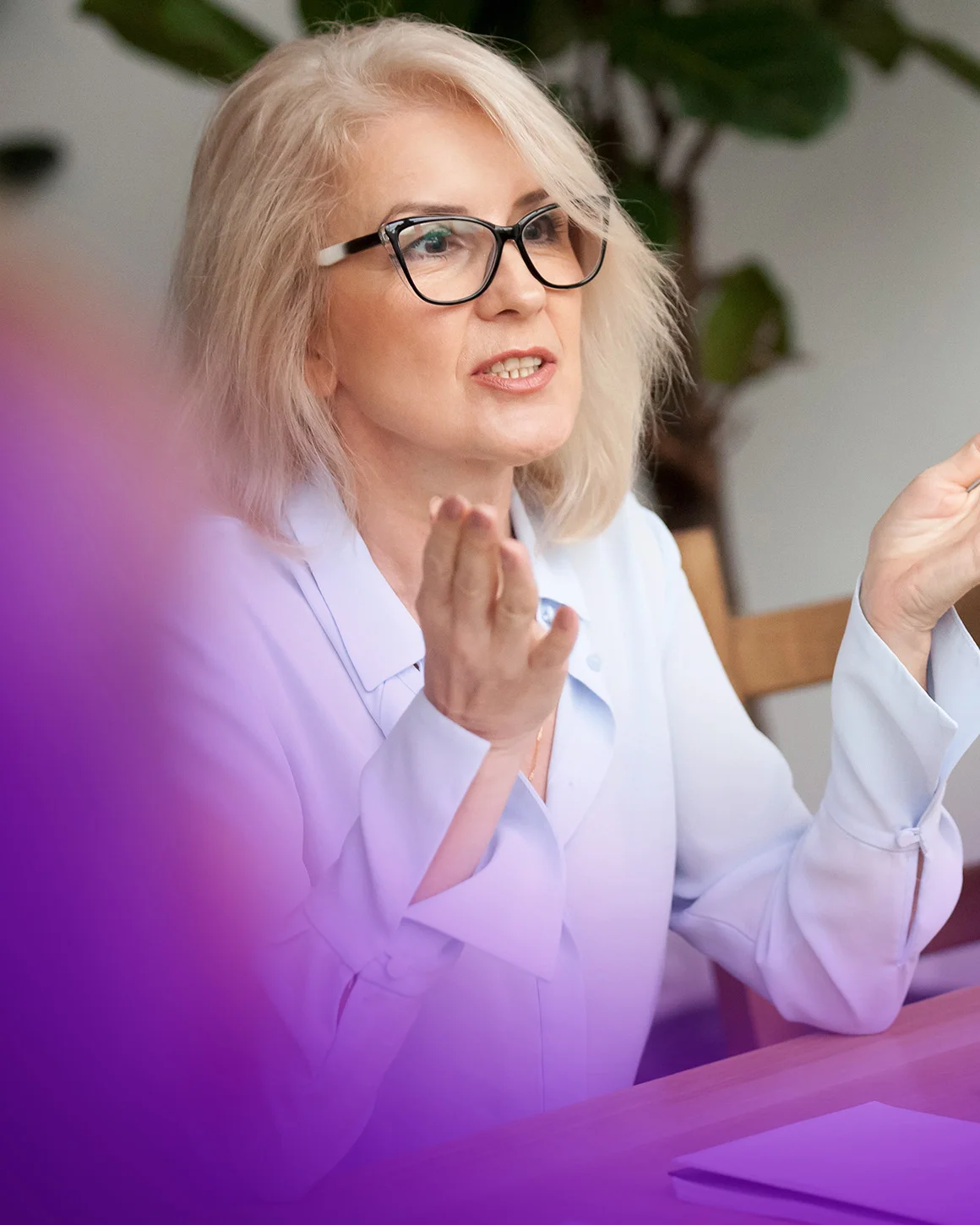 woman in black glasses gesturing