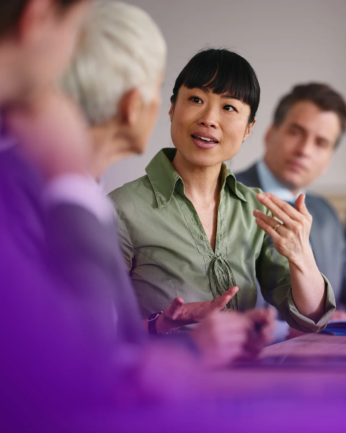 woman gesturing at conference table meeting