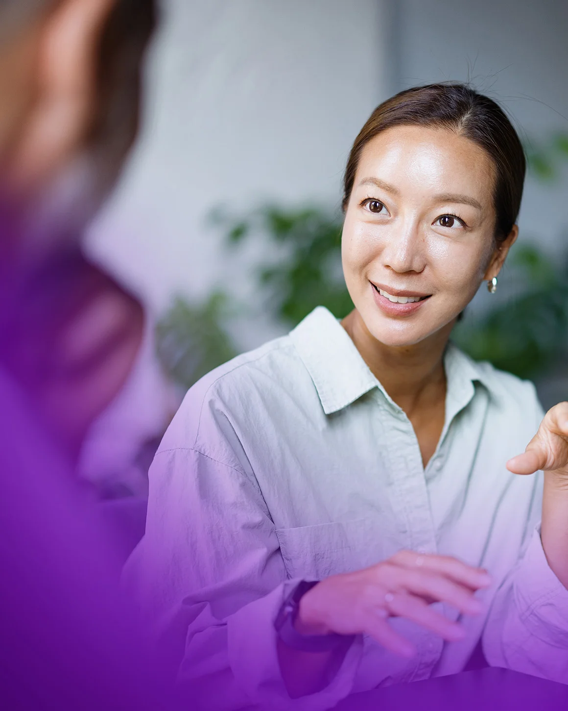 woman gesturing while having a conversation