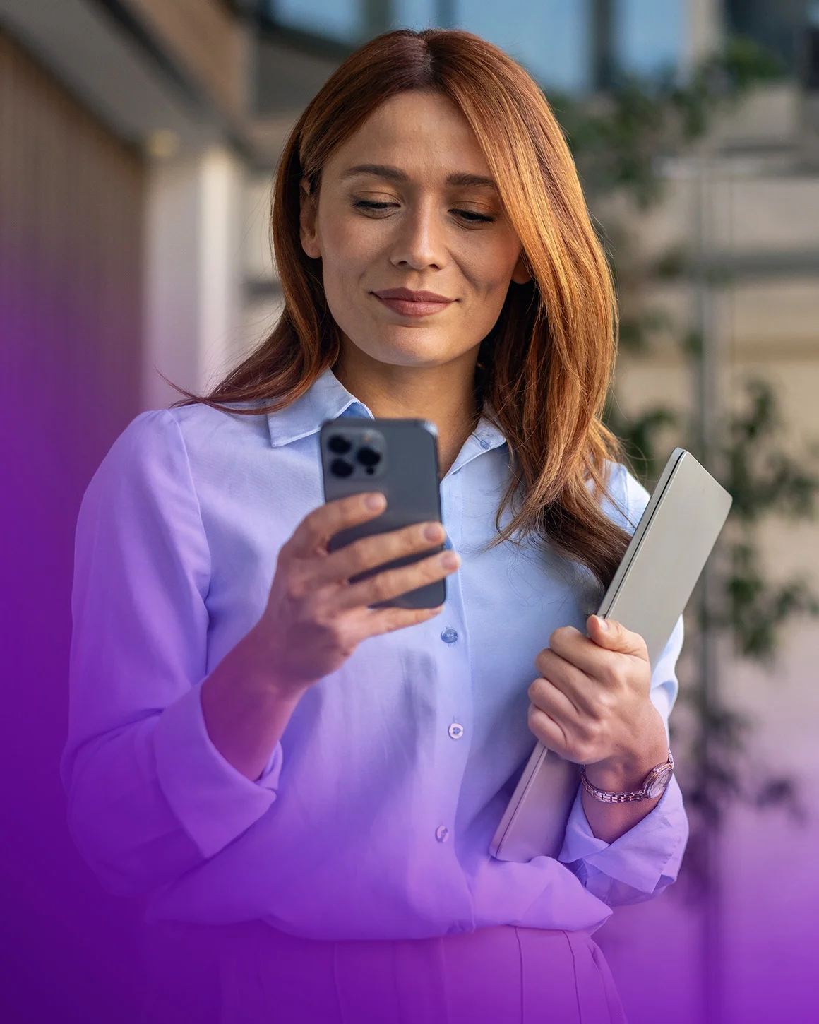 woman looking at her phone and smiling