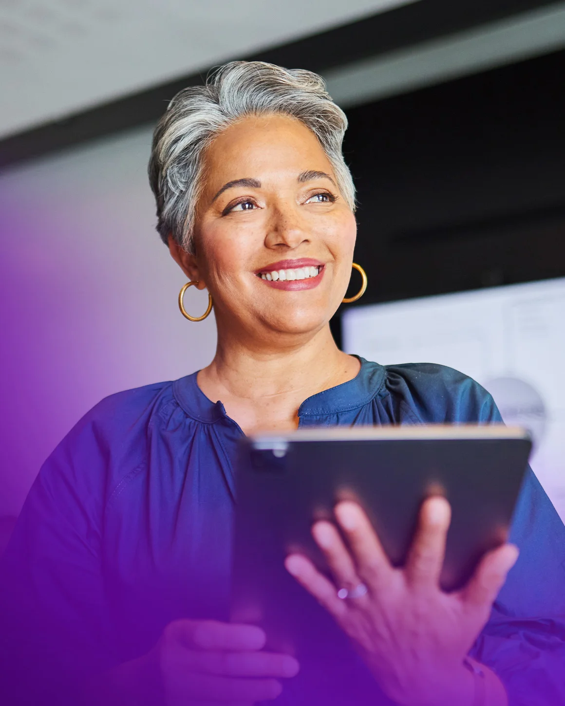 woman wearing blue shirt using tablet