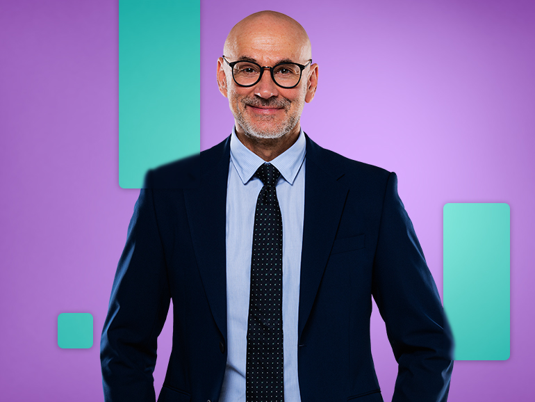 man wearing glasses and a navy suit hero image