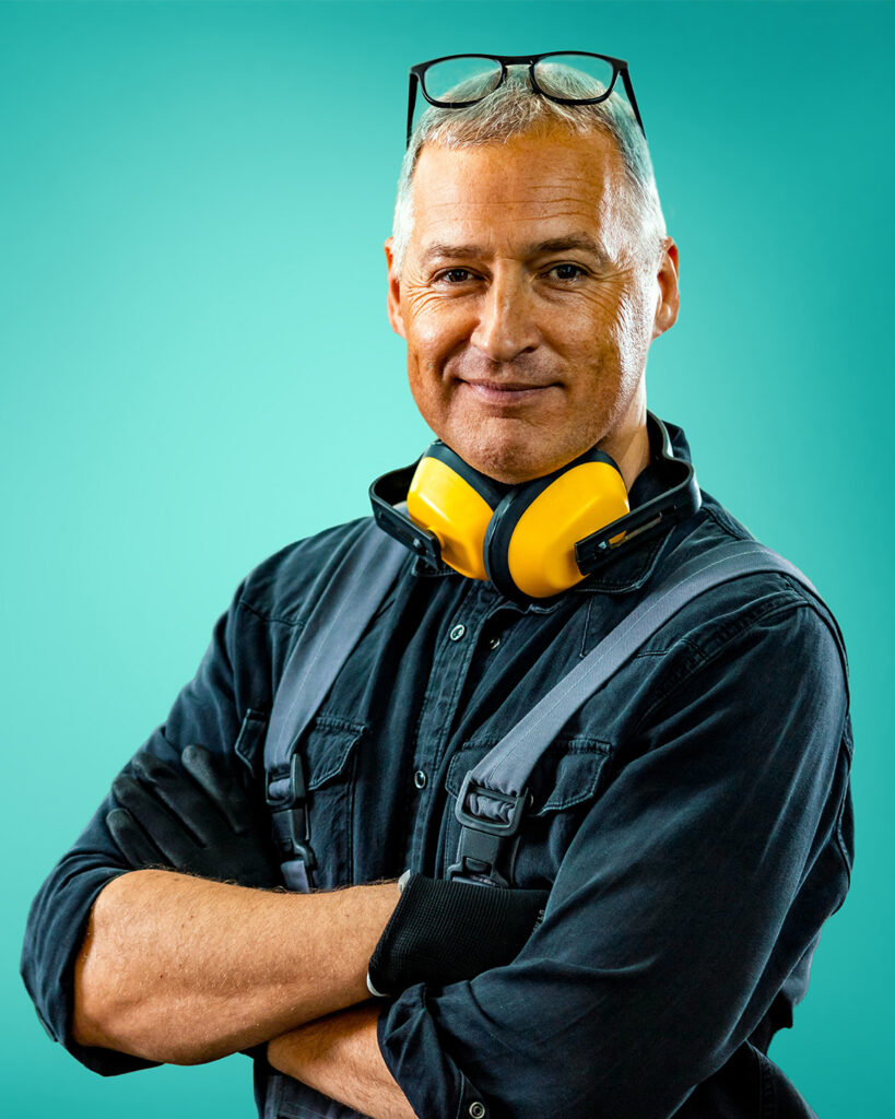 man wearing overalls and earphones