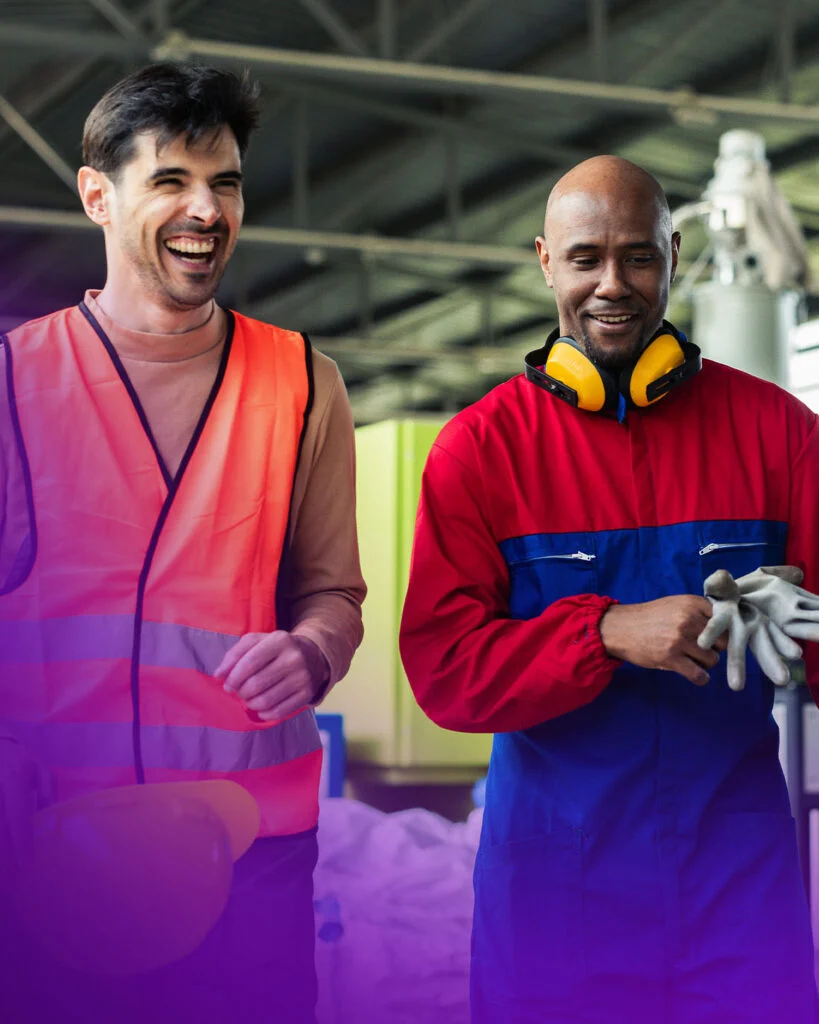 two men wearing orange vests and earphones